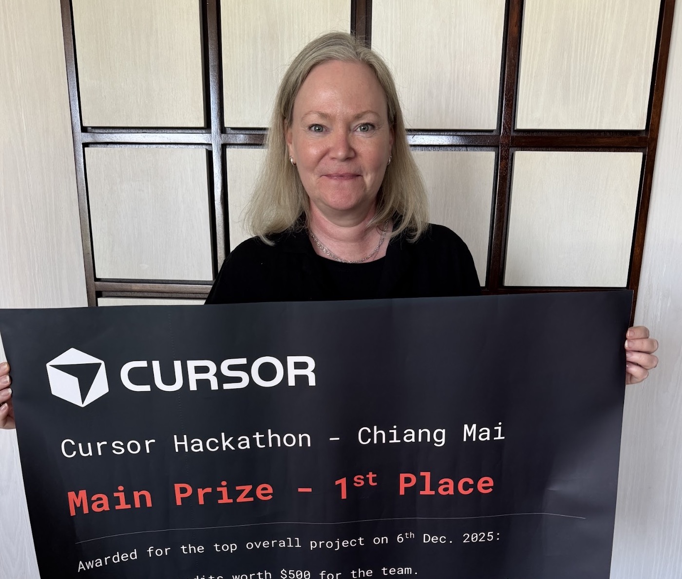 Nina Kolari holding the Cursor Hackathon 1st place award banner